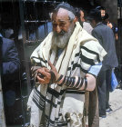Israel, Jerusalem, Ashkenazi Jew winding the tefillin bands and wearing the tallit (prayer shawl) before prayers at the Western Wall