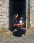 Bedouin woman spinning wool for rug making, Jordan