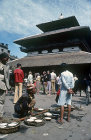 Curd seller in front of sixteenth century Kasthamandap Temple, after which Kathmandu is named, Maru, Kathmandu, Nepal