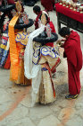 Dancers in traditional costumes being given refreshments, Tiji Festival, Lomanthang, Upper Mustang, Nepal