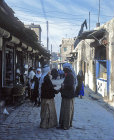Syria, Aleppo, a street in the Suq, two Arabs in conversation