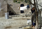 Girl outside dwelling house, citadel, Apamea, Syria
