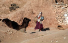 Berber woman with camel, amphora and bucket, Tunisia
