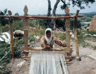 Nomad girl working at a loom near Eleusis, Cilicia, Turkey