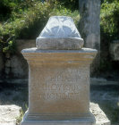 Relief of cross and Greek inscripton on base in main colonnaded street, Perge, Turkey